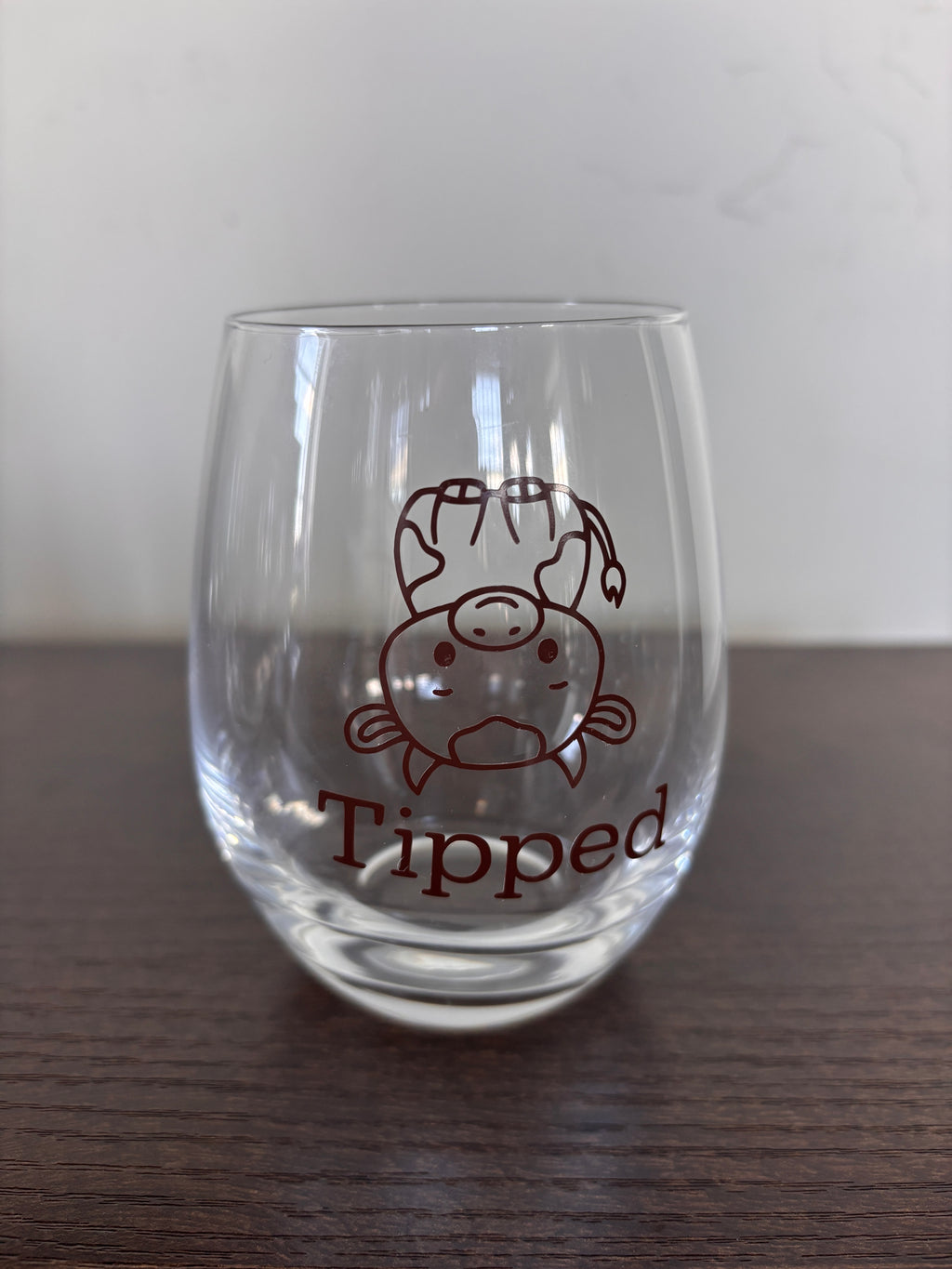 Tipsy or tipped stemless wine glass