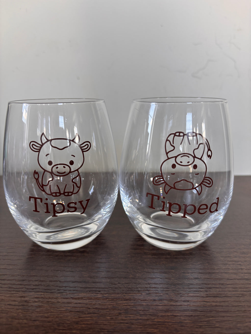 Tipsy or tipped stemless wine glass