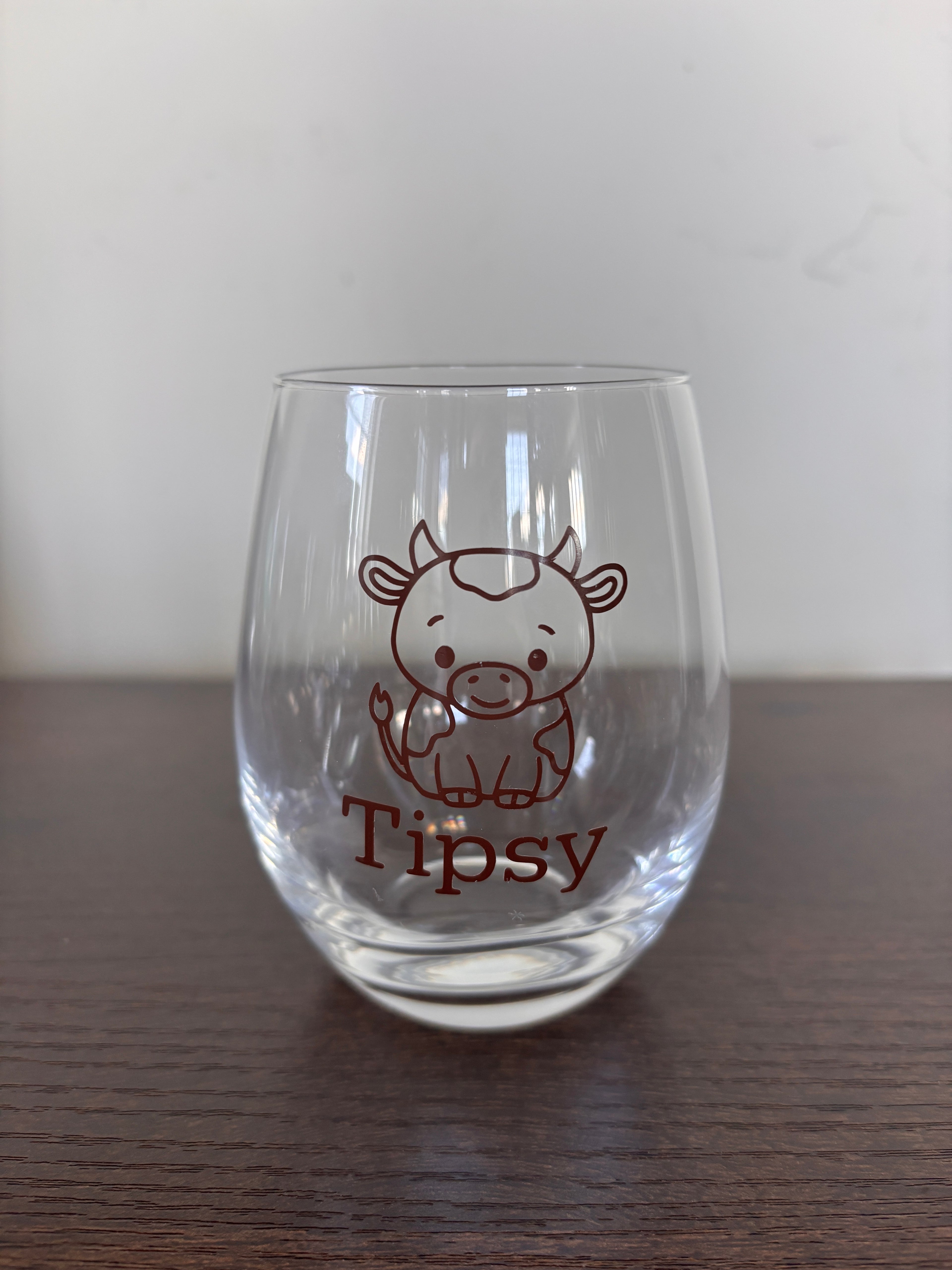 Tipsy or tipped stemless wine glass